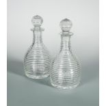 A pair of large 19th century decanters and stoppers, with faceted globular bodies and fluted