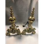 A pair of 19th century continental brass andirons, probably Dutch, the bases modelled with lion