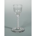 A George III cordial glass, the spirally fluted bowl on a cotton twist stem, 14cm (5.5in) high