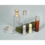 A small collection of miniature scent bottles, to include a gilt metal and enamel mounted glass