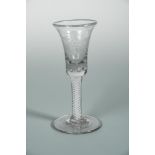 A George III cordial glass, the bell shaped bowl engraved with foliage, on an air twist stem and