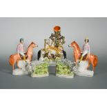 A collection of 19th century Staffordshire pottery figures, to include a pair of rearing Zebras,