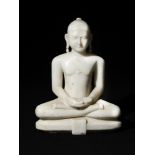 A 19th century Indian Jain marble Tirthankara figure, modelled seated in the lotus position upon a