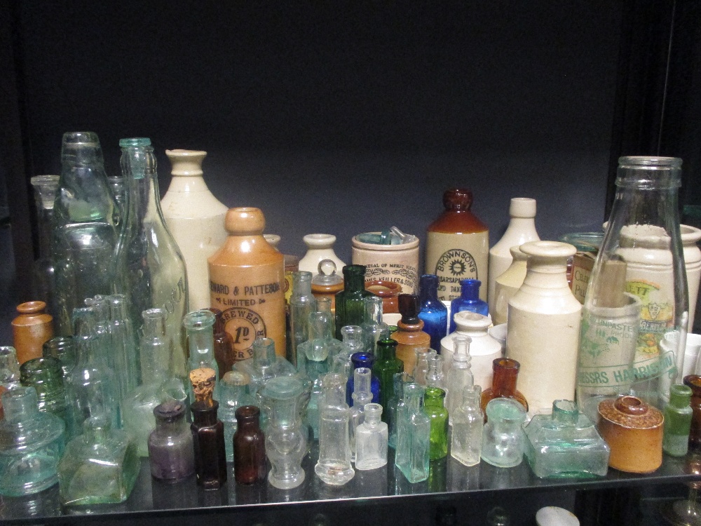 A very large quantity of glass bottles of varying sizes, salt glazed jars and various oil lamps - Image 5 of 11