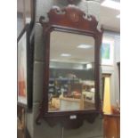 An 18th century mahogany fret framed wall mirror, inlaid with a roundel, 74 x 43cm