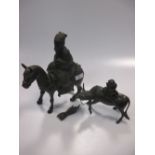 An Asian bronzed metal horse and rider (loose tail), together with another metal figure of an ox