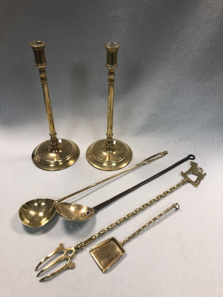 A 19th century decorative brass and iron cream skimmer, together with a pair of slender brass