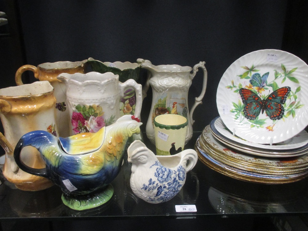 Floral jugs and teapots together with vintage tin picnic plates and china plates decorated with