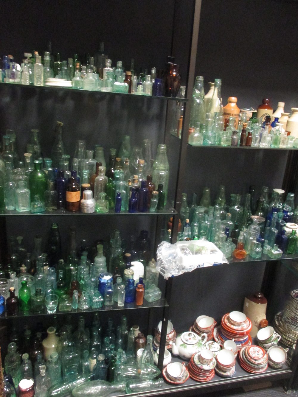 A very large quantity of glass bottles of varying sizes, salt glazed jars and various oil lamps - Image 11 of 11