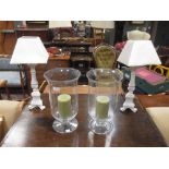 A pair of modern glass storm lamps and a pair of wooden table lamps (4)