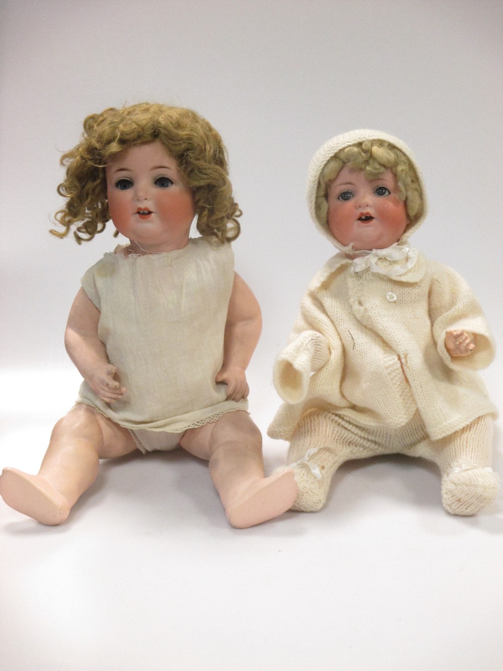 Three bisque head dolls and a composition head baby doll (4)