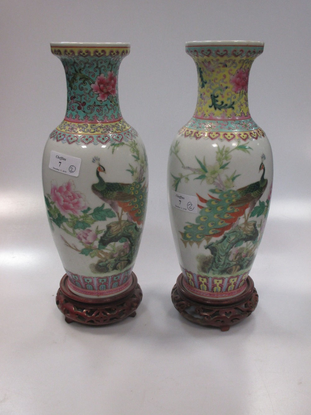 Two similar Chinese vases, 20th century, decorated with peacocks and famille rose decoration, 26cm