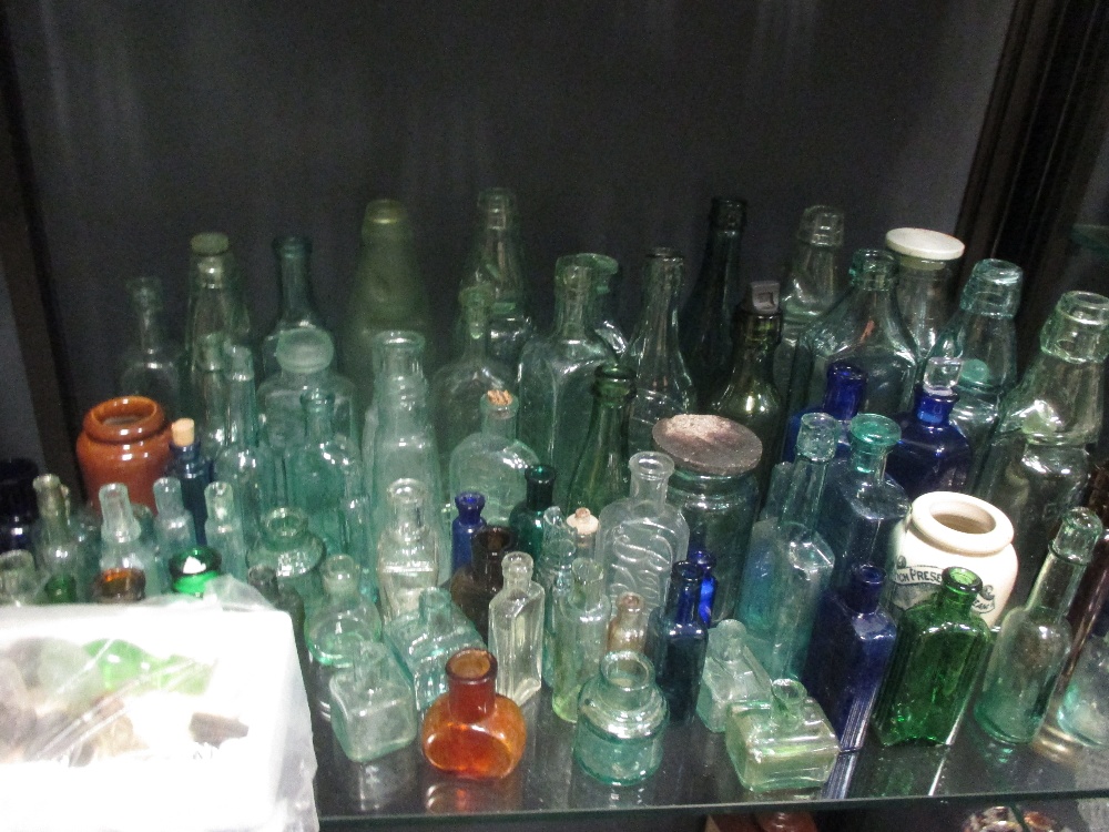 A very large quantity of glass bottles of varying sizes, salt glazed jars and various oil lamps - Image 6 of 11