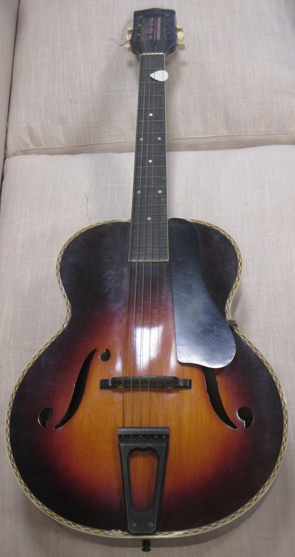 A Broadway Harmony H954 acoustic guitar, arched top model with sunburst effect and case