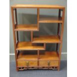 A 20th century oriental hardwood bookcase with two drawers, stamp to underneath reads J. L. George &