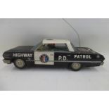 A Japanese tinplate model of a Chevrolet Impala Highway Patrol vehicle.