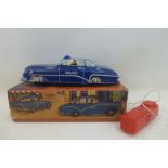 A 1950s tinplate remote controlled Police car, near mint and boxed, appears unplayed with.