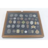 A framed and glazed display of 38 Third Reich and other military badges.