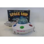 A boxed battery operated spaceship, made in Hong Kong.