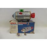 A boxed Japanese tinplate space capsule with floating astronaut, by Masudaya.