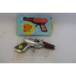 A boxed Chinese tinplate Sparking Pistol.