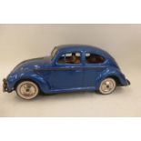 A wind-up tinplate model of a VW Beetle made by Yoshiya/Kobe Yoko Limited, Japan.