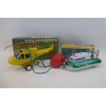 A boxed battery operated remote controlled helicopter, made in Hong Kong and a boxed hovercraft with