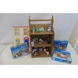 A dolls house with Playmobil contents and three unopened boxed sets of Playmobil.