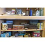 A shelf full of assorted tins.