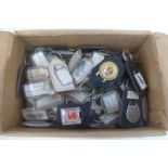 A box of assorted keyrings including motoring.