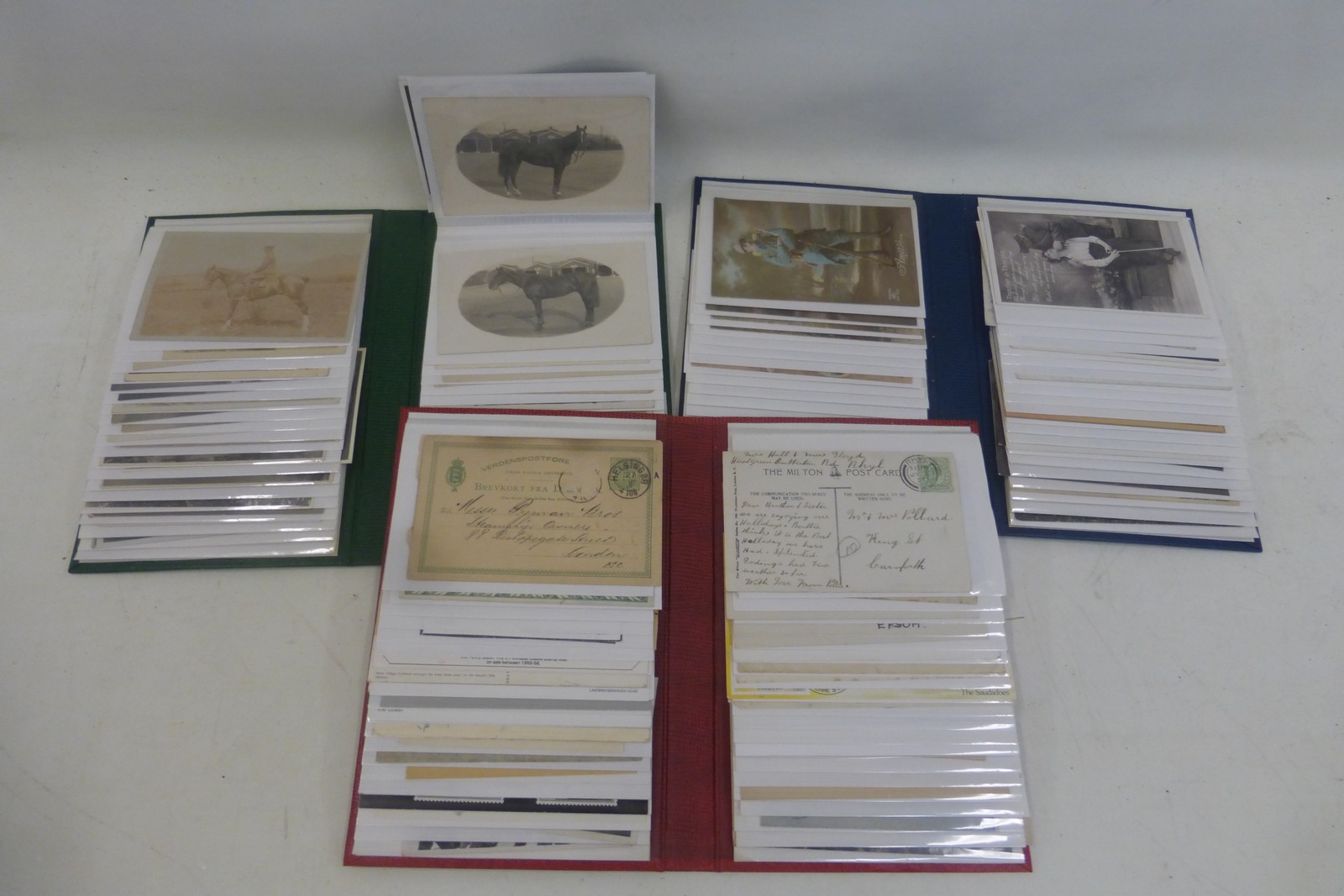Three albums containing a total of 240 military postcards and photographs.