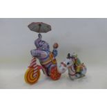 A Japanese clockwork tinplate model of a monkey sat on an elephant riding a trike and a Mikuni