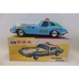 A boxed Chinese tinplate model of a Highway Patrol car.