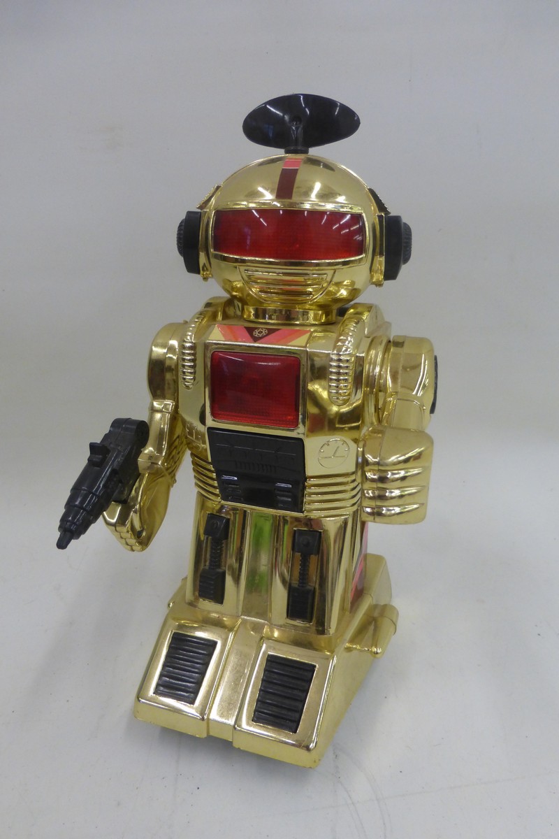 An unusual gold coloured plastic robot.