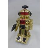 An unusual gold coloured plastic robot.