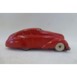 A clockwork tinplate model of a streamlined motorcar.