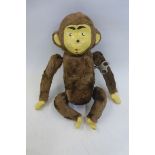 A clockwork figure of a monkey with composite face and limb pads, the key marked Made in Hong Kong.