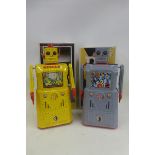 Two large Chinese reproduction tinplate R1 robots.