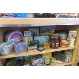 A shelf full of tins including Huntley & Palmers.