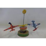 A West German tinplate model of two aircraft spinning around.