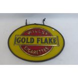 A Wills's Gold Flake Cigarettes oval glass sign in a metal frame (cracked), 18 x 13 1/4".