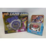 A boxed battery operated spaceship with Mystery Action blinking light, made in Hong Kong and a laser