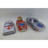 A Japanese tinplate model ambulance, a Japanese clockwork tinplate racing car and a Japanese