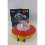 A boxed Rosenthal Toys Limited battery operated flying saucer, made in Hong Kong.