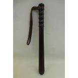 A hardwood police truncheon approximately 14 1/2" in length with a leather wrist band.