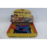 A boxed Remco electronic space gun, in original picture card display box.