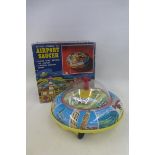 A boxed Japanese battery operated airport saucer by Masudaya.