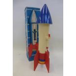 A boxed plastic rocket bank, made in Hong Kong.