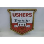 An Ushers of Trowbridge shaped enamel sign set within original fibreglass frame, 23 x 22 1/2".