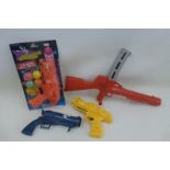 An assortment of plastic guns to include a Marx bongo gun.